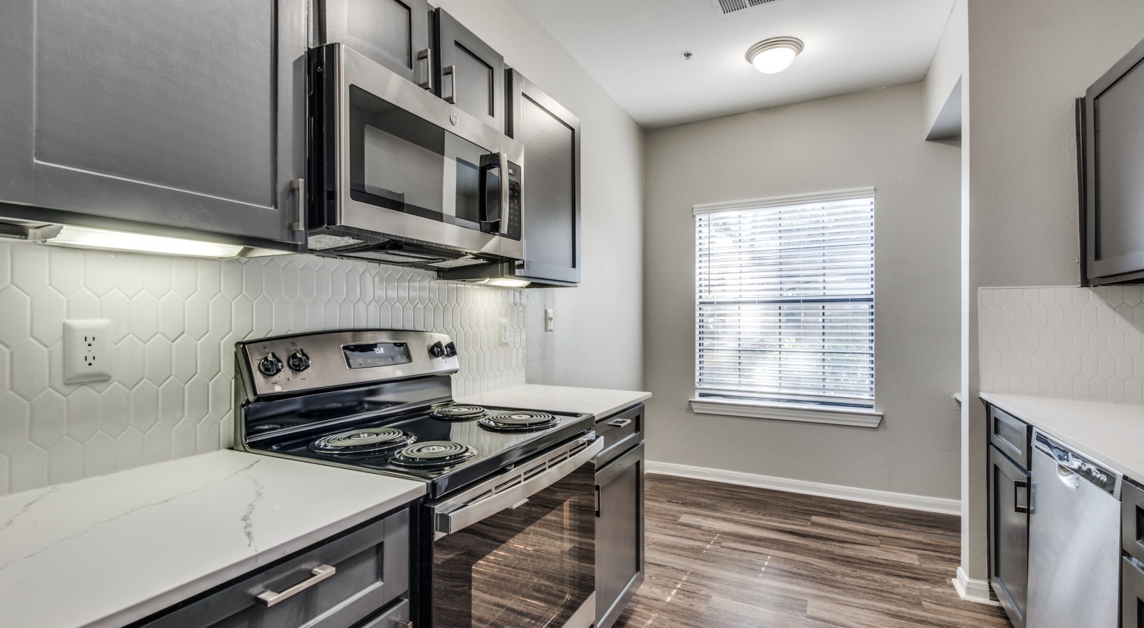 kitchen with stainless steel appliances and black cabinets at The  Vincent
