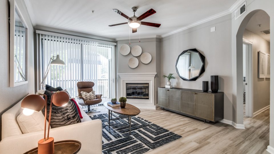 a living room with a ceiling fan and a couch at The  Vincent