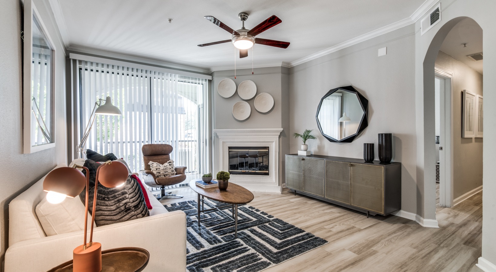 a living room with a ceiling fan and a couch at The  Vincent