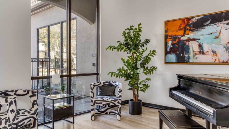 a piano sits in front of a large window at The  Vincent