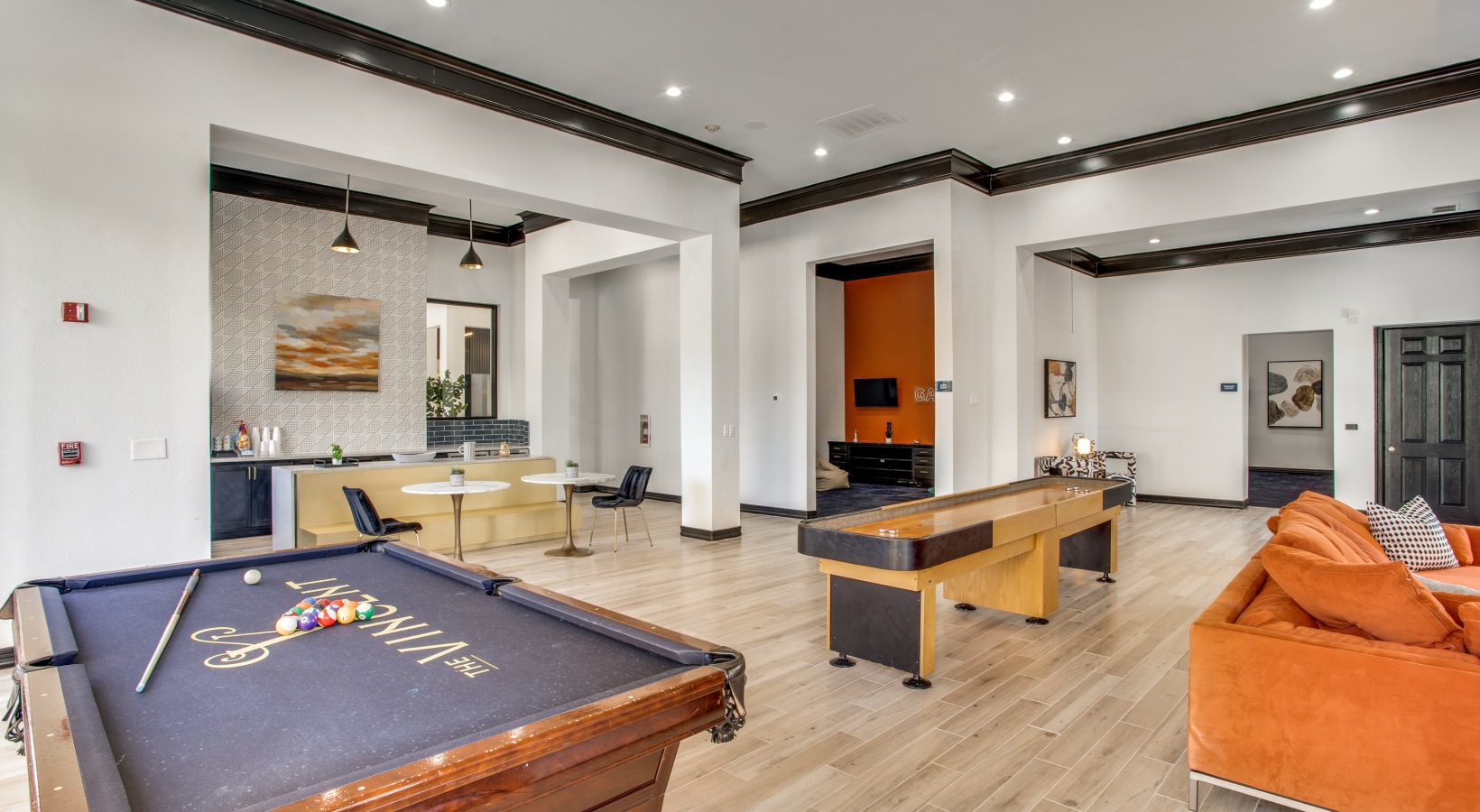 a pool table and billiard table in a living room at The Vincent